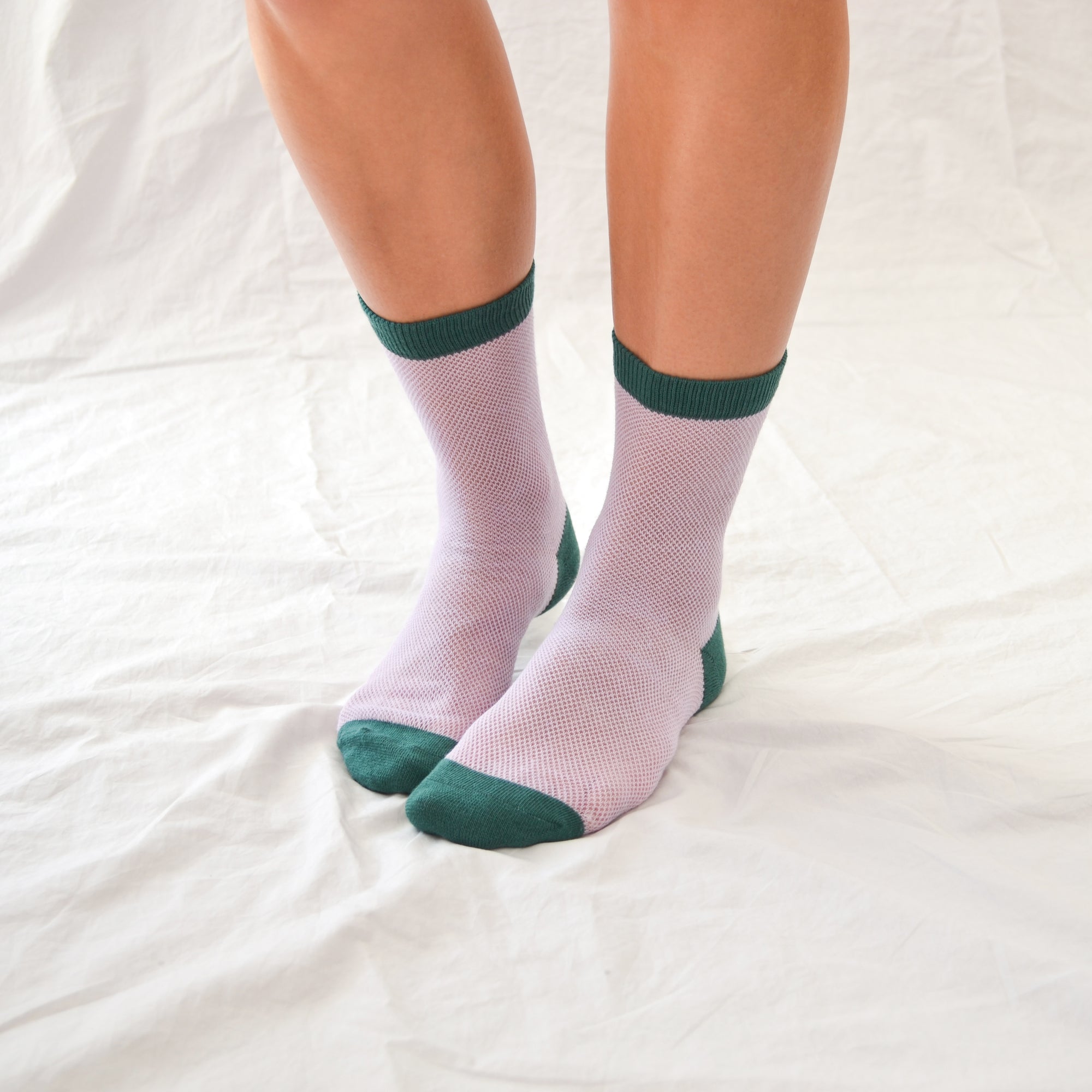 'Valencia' mid-crew socks, showcasing an open mesh sheer design in Cantaloupe, Pink, and Purple, effortlessly blending breathability and chic style. Size: Small (US women’s shoe size: 4-8).