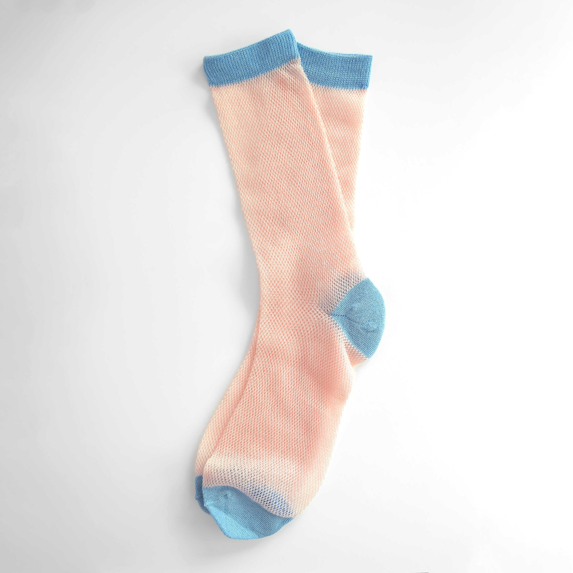 'Valencia' mid-crew socks, showcasing an open mesh sheer design in Cantaloupe, Pink, and Purple, effortlessly blending breathability and chic style. Size: Small (US women’s shoe size: 4-8).